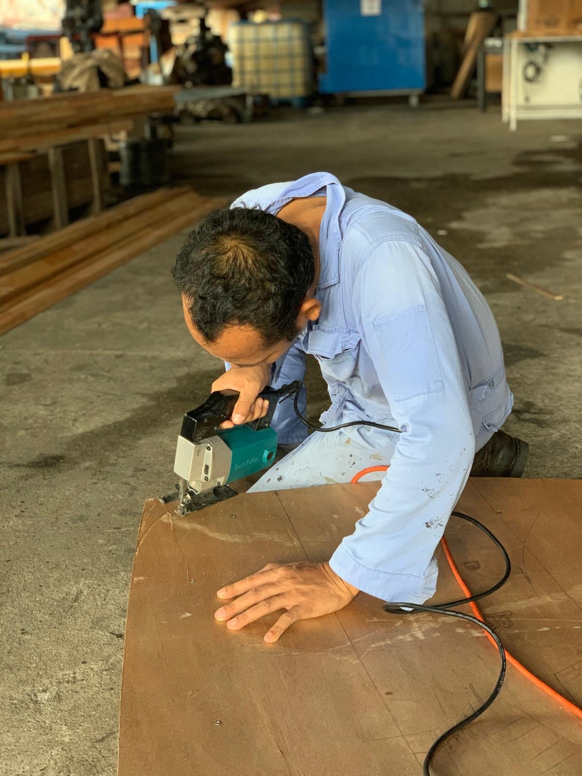 Craftsman cutting sustainable marine timber for vessel carpentry